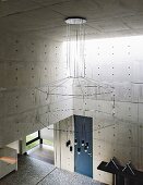 Impressive chandelier with geometric silhouette in architect-designed concrete house