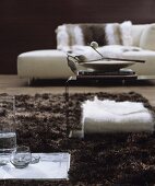 White and brown living room with modern chaise and side table on long-pile rug