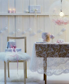 Romantic Christmas arrangement in white with lace tablecloth, furs & baubles