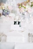 Place setting with name card on wedding table outdoors