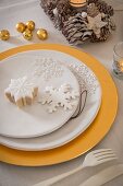 Snowflake ornaments on plate on gold charger plate