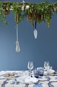 Arrangement of fir branches suspended above set table