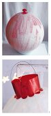 A Christmas tree bauble being made from a balloon and silk paper