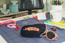 An embroidered glasses case
