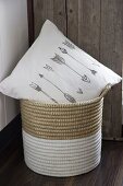 White scatter cushion printed with arrow motifs in dip-dyed basket