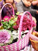 Basket of autumnal flowers as decoration for autumn picnic