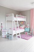 White bunk beds with latter in corner of children's bedroom painted pale grey