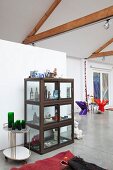 Display cabinet in loft apartment with exposed roof structure