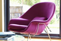 Purple retro shell armchair in front of sliding terrace doors