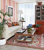 Bookcase, rug and ethnic cushion covers in traditional living room
