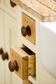 Small oak drawers labelled Bits and Bobs in kitchen base unit