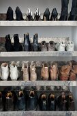 Ladies' shoes on metal shelves in shoe cabinet