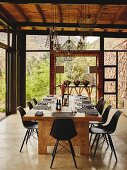 Set, solid wooden dining table and black retro shell chairs