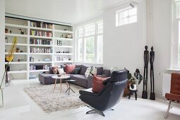 Fitted shelving and designer furniture in living room