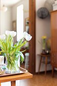Vase of white tulips against blurred background