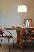 Pendant lamp above rustic wooden table with chunky turned legs