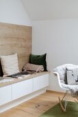Bench with storage space and wooden panel on wall