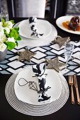 Black and white place setting on a Christmas table