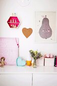 Toys and pictures on a sideboard in a child's room