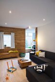 Corner sofa, wood-clad wall and custom bench in lounge area