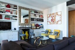 Fitted shelves and eclectic furnishings in living room