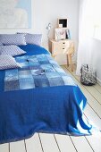 Blue blanket with patchwork detail made from old jeans
