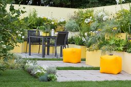 Terraced flowerbeds in various shades of yellow in courtyard garden