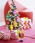 Small fir tree decorated with magic tree air fresheners and car-shaped baubles