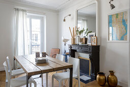 Wooden table and plastic chairs in dining room of period apartment