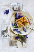 Crumb cake and grape hyacinths arranged on vintage plate