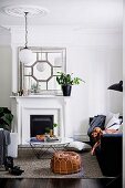 Traditional living room with fireplace and stucco rosette, dog on couch