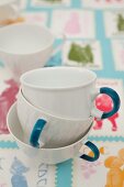Cups with handles painted using china pens