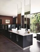 White countertop basins, tall mirrors, bathtub and glass wall in designer bathroom
