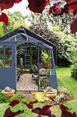 Anthracite greenhouse with sliding door in the garden