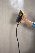 Removing wallpaper using a steamer