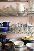 Crockery on open metal shelves in kitchen