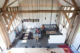 View down into living area with light-bulb pendant lamps in converted barn