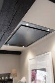 An extractor fan built into an illuminated ceiling
