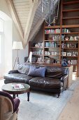Leather sofa and bookcase in attic lounge area