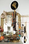Costume jewellery hung on jewellery stand in front of mirror