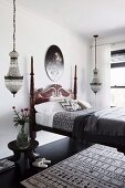 Colonial style bed with carved bed head, pendant lights on both sides in the bedroom