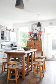 Bar stools around wooden table in kitchen