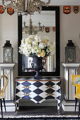 Ornate, square plinths and designer chair in artistic hallway