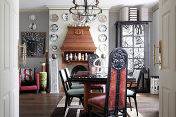 Striped wallpaper and decorative, designer wall plates in artistic dining room