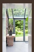 View through doorway of stone bench in conservatory extension