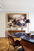 Dining area in restored period apartment with large artwork
