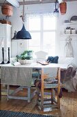 Rustic furniture and textiles in shabby-chic dining room