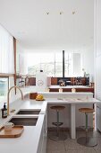 Designer kitchen with breakfast bar in open-plan interior