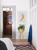 Bedroom with white built-in wardrobe and retro flair, view of bathroom ensuite