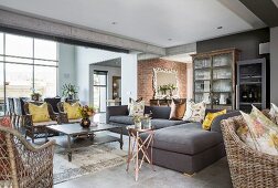 Sofa set and wicker furniture in lounge with concrete ceiling beams
